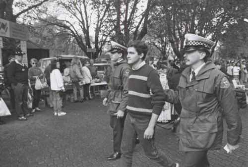 Tasmanian gay activist Rodney Croome arrested at Salamanca Market 1988. Photograph copyright Tasmanian Times. Used with their kind permission.